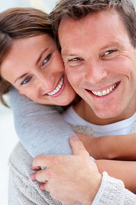 Closeup portrait of a cute young female hugging her husband from behind