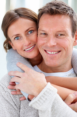 Closeup portrait of a happy young female hugging her husband from behind