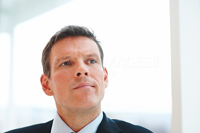 Closeup portrait of a handsome young business man day dreaming