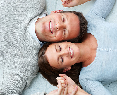 Portrait of young couple lying down besides eachother with their eyes closed