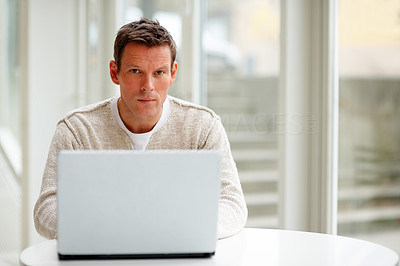 Portrait of happy man working on laptop
