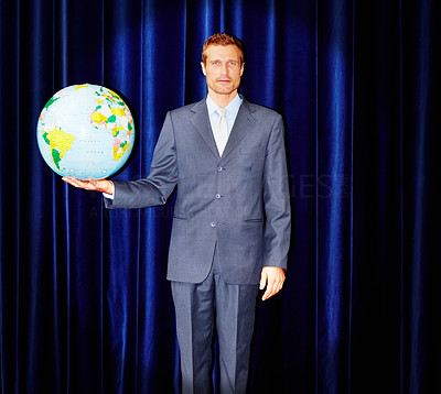 Portrait of successful business person holding a globe