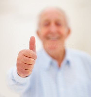 Blurred image of old man showing thumbs up