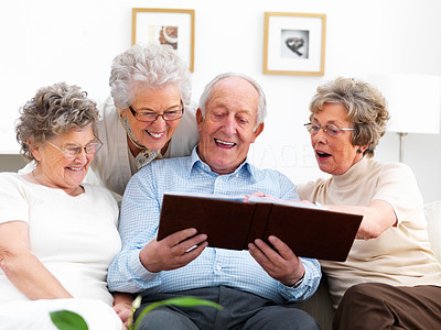 Mature people looking at photo album