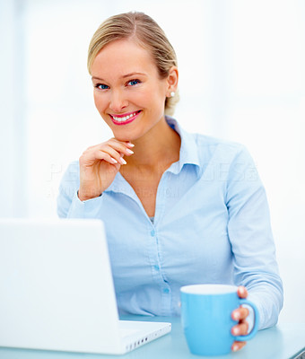 Friendly woman in business sitting with laptop
