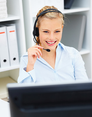 Happy young office worker wearing headset