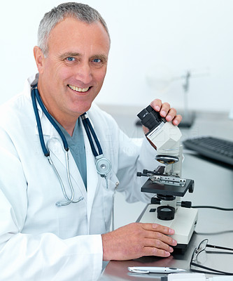 Closeup of a doctor using microscope