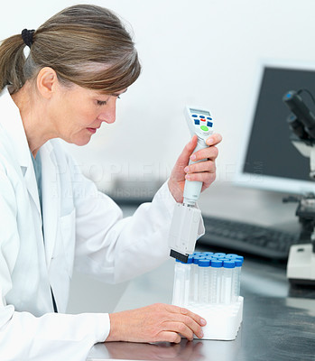 Scientist testing vials in a lab