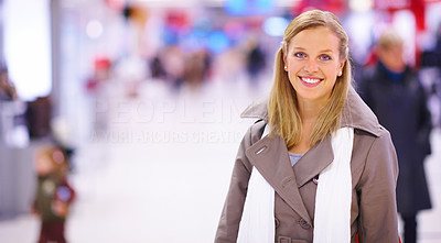 Beautiful young lady standing in shopping centre