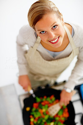 Top view of a young beautiful woman cooking food in kitchen