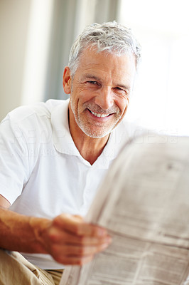 Handsome senior man reading a newspaper