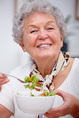 Closeup of an old woman sitting and having food