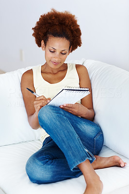 Relaxed woman writing in book