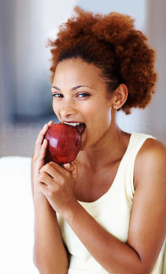 Woman holding apple and eating it