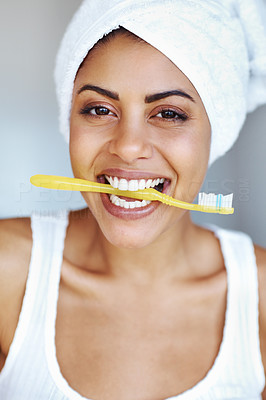 Playful woman holding tooth brush in mouth