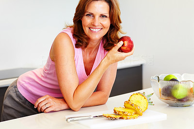 Beautiful young woman holding an apple - Kitchen