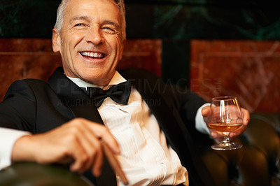 Cheerful man with brandy and cigar