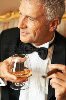 Smiling gentleman with cigar and brandy