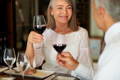 Senior couple with wine glasses at restaurant