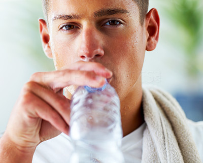 Young man drinking water after a workout
