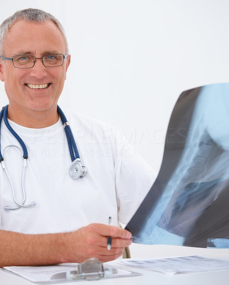 Mature doctor checking x ray on white