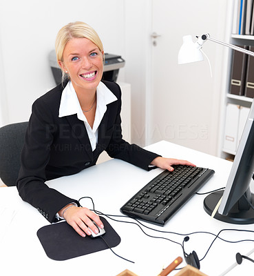 Happy business woman using computer and smiling