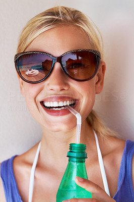 Attractive young woman drinking soft drink