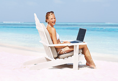 Woman with laptop on deck chair
