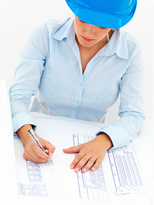 Female architect working on blue prints, isolated on white background