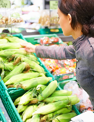 Woman buying green vegetables