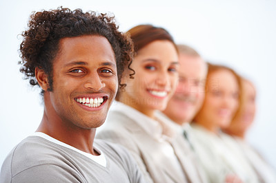 Closeup of a smiling business man with executives against white
