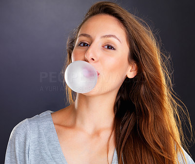 Woman blowing a bubble with bubble gum