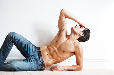 Relaxed young male fashion model posing