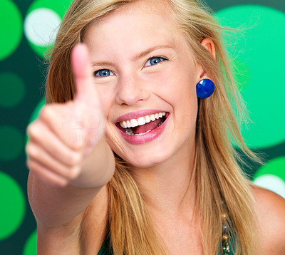 Excited young lady showing thumb\'s up sign
