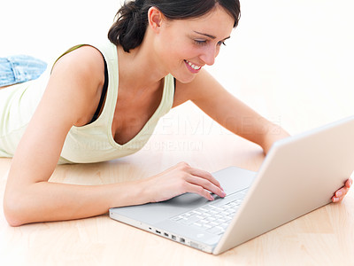 Portrait of a happy young lady working on laptop