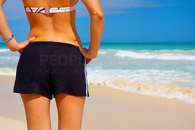 Girl in Bikini and Shorts on the Beach