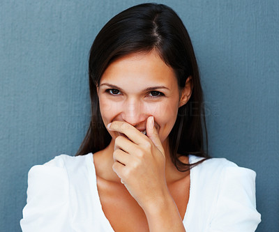 Shy woman with hand over mouth