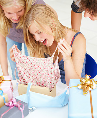 Young girl opening birthday present