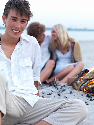Happy young guy with friends in the background