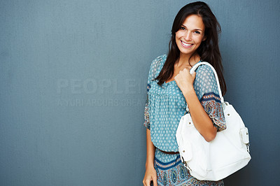 Smiling brunette carrying purse