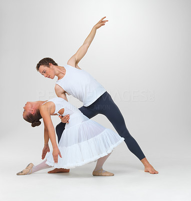 Two ballet dancers performing against white - copyspace