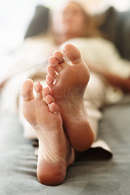 Macro view of blur woman\'s feet resting in bed