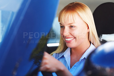 Smiling young female in the front seat of an automobile