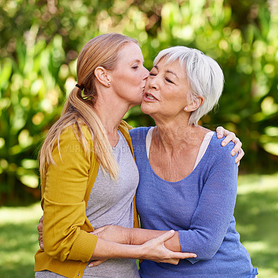 Cropped shot of a woman kissing her mother in the yard - stock photo #12707...