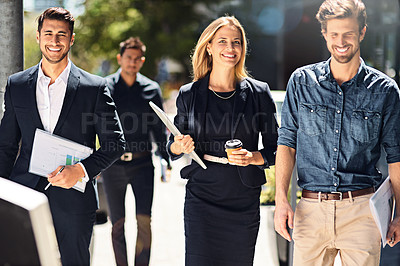 Buy stock photo Shot of corporate colleagues walking down the street