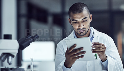 Buy stock photo Shot of a scientist recording his findings on a digital tablet