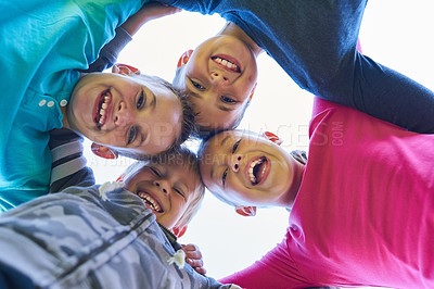 Buy stock photo Portrait of a group of young children in a huddle outdoors