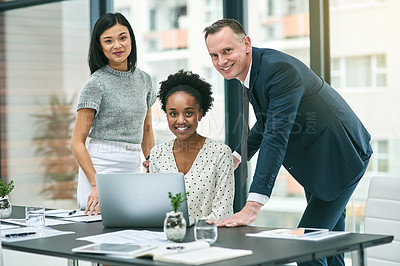 Buy stock photo Cropped portrait of three businesspeople gathered around a laptop in the office