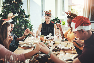 Pics of Cropped shot of a group of young friends saying grace while dining together at Christmas, stock photo, images and stock photography PeopleImages.com. Picture 2016238