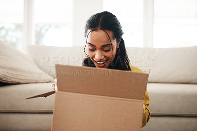 Pics of Cropped shot of an attractive young businesswoman sitting alone on her living room floor and opening up a mystery box, stock photo, images and stock photography PeopleImages.com. Picture 2016752